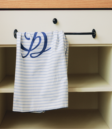 A Gardeny-branded towel hanging loosely from a drawer, captured in warm natural light. The soft folds and minimal, calming setting reflect Gardeny’s skin-first philosophy and the simplicity of daily self-care. The scene evokes the brand’s gentle, rose-powered approach to hydration, comfort, and soothing routines inspired by clean, effortless Korean beauty.