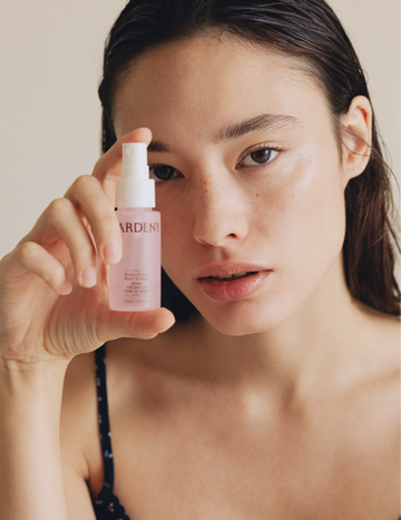 Model holding the Gardeny Rose PDRN Mist Toner close to her face, emphasizing the lightweight Korean plant-based PDRN formula that delivers deep hydration, smoother texture, and a natural glow. Shows how the mist functions as both a first-step toner and an anytime refreshing hydration spray powered by Damask Rose PDRN for dewy, calm, comfortable skin.