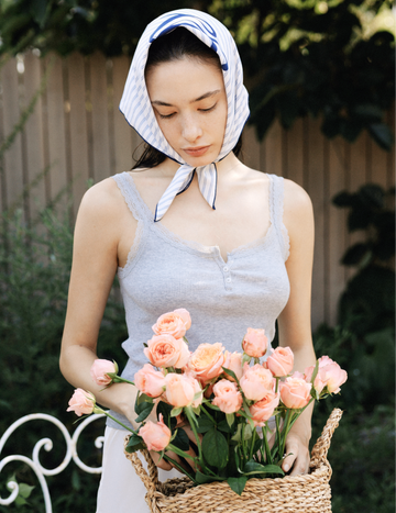 Woman holding a basket filled with fresh pink roses, representing Gardeny’s flower-powered skincare identity rooted in plant-based Damask Rose PDRN. The visual highlights the natural, soothing, and hydrating qualities of Gardeny formulas, designed to support radiant, calm skin through gentle Korean skincare science that blends botanical purity with lightweight daily moisture.
